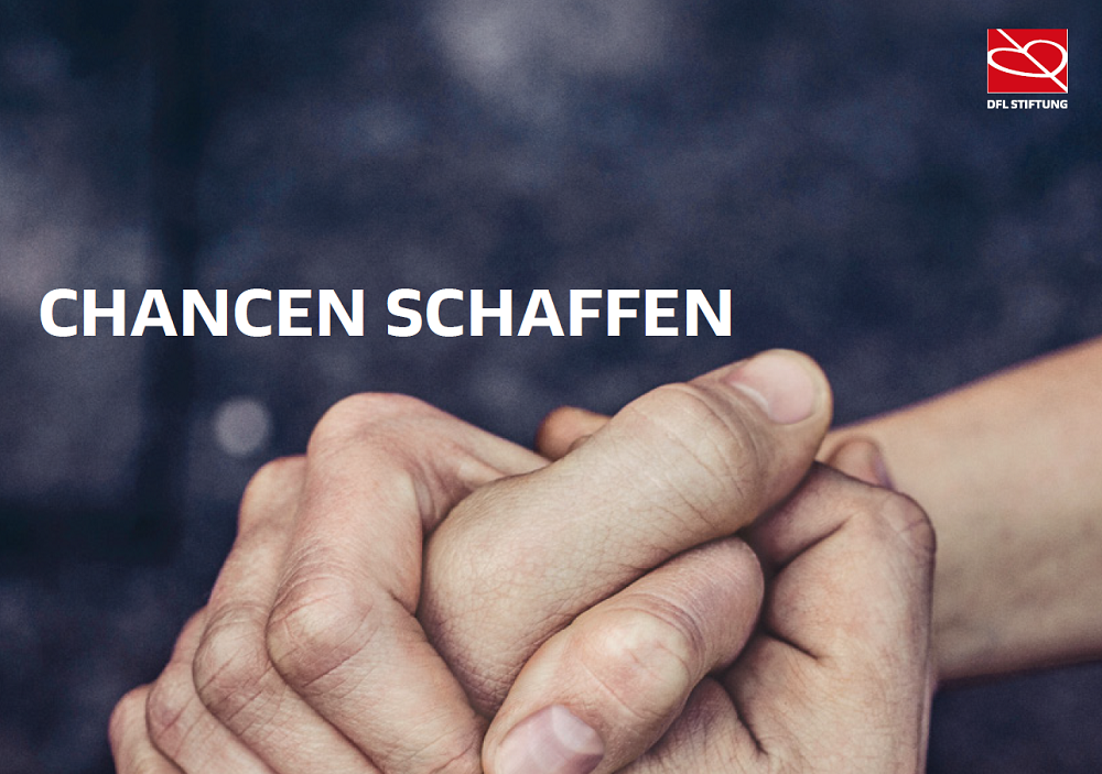 The photo shows two interlocked hands on a dark gray background and the words 