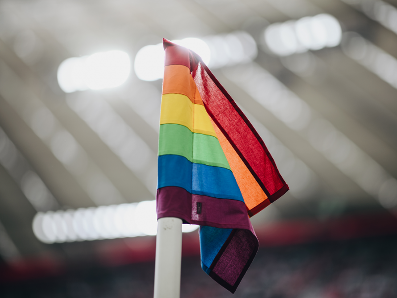 Eine Regenbogeneckfahne weht im Fußballstadion.