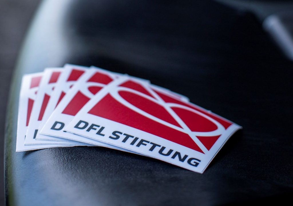 DFL foundation sticker on seat in stadium.