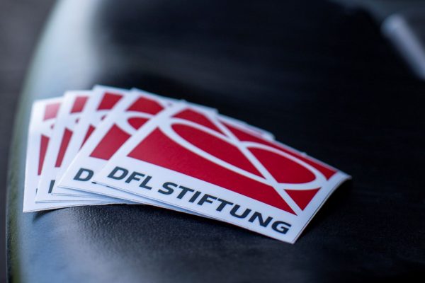 DFL foundation sticker on seat in stadium.