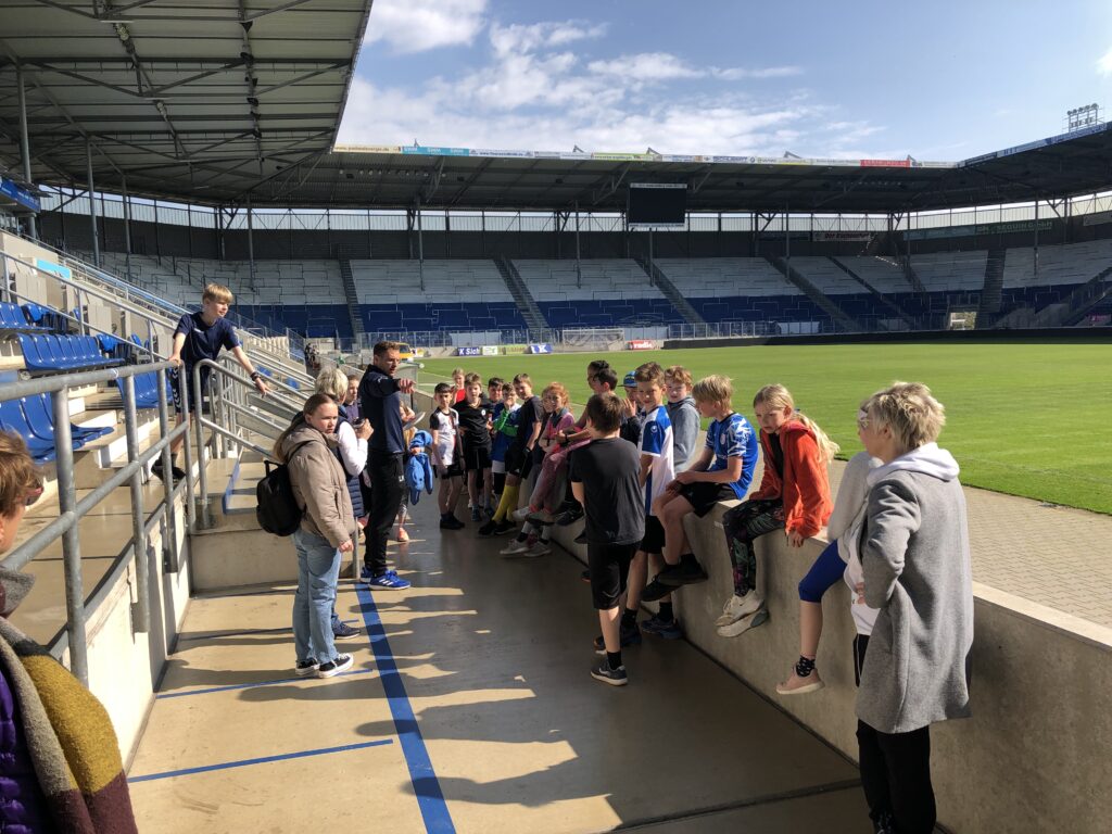 Kinder besuchen ein Fußballstadion.